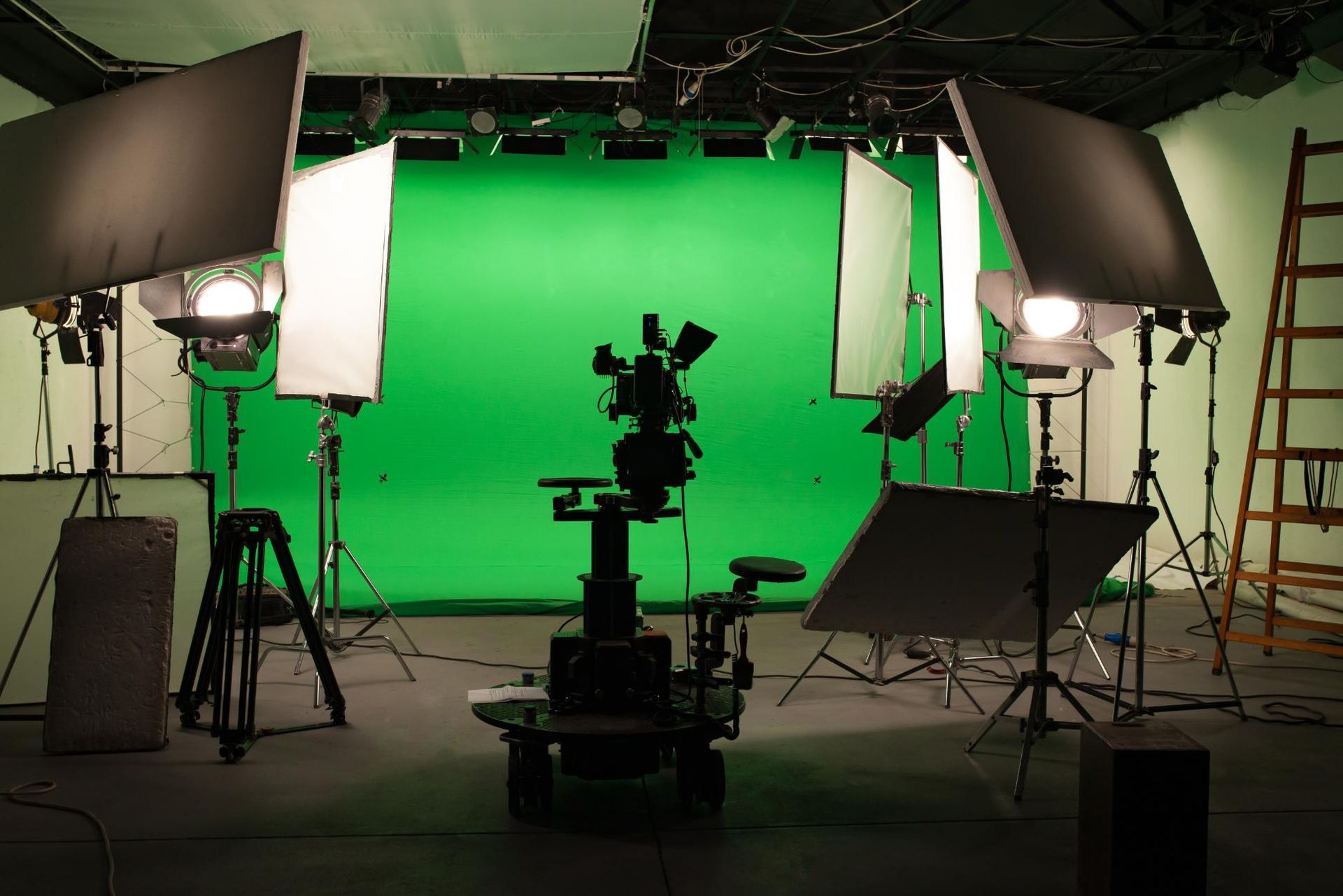 A studio with a green screen and lots of lights
