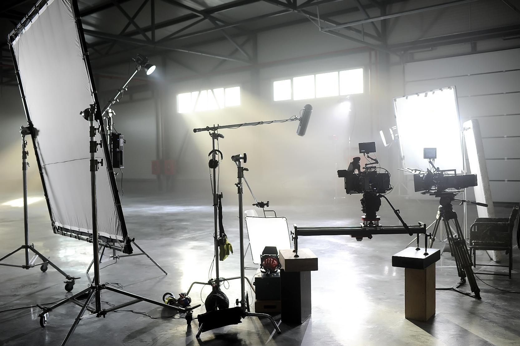 A warehouse filled with lots of cameras and lighting equipment.