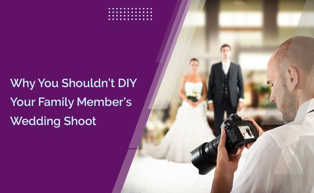 A man is taking a picture of a bride and groom with a camera.