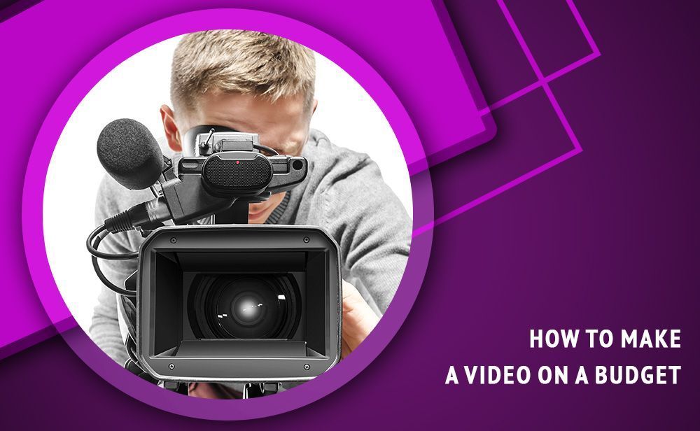 A man is holding a video camera in front of his face.