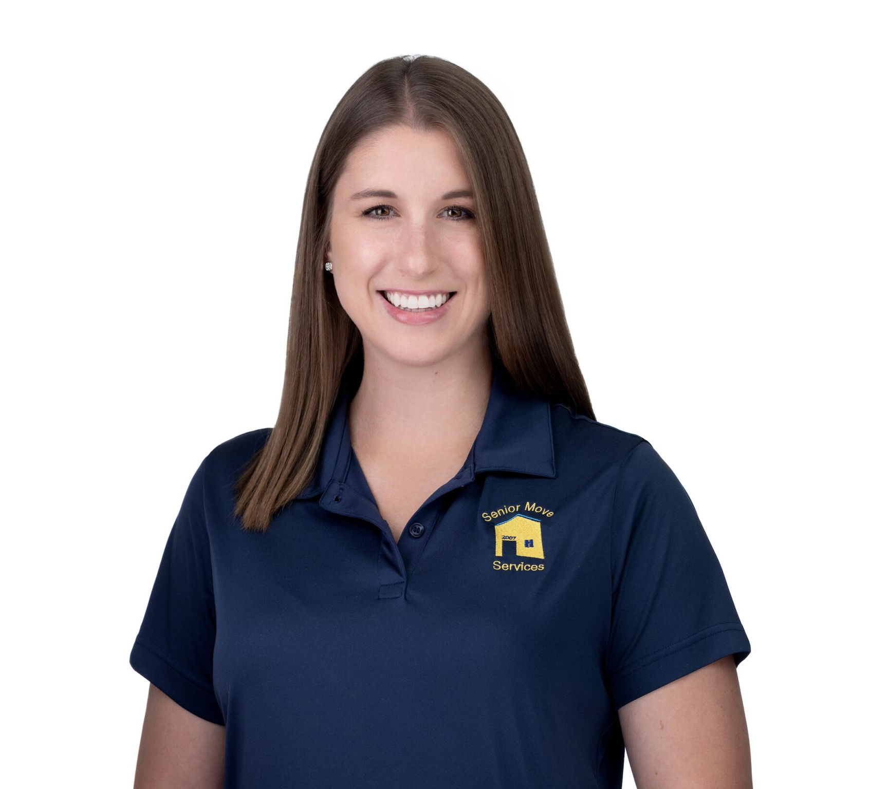 Woman in navy blue polo shirt with logo smiles, light brown hair.