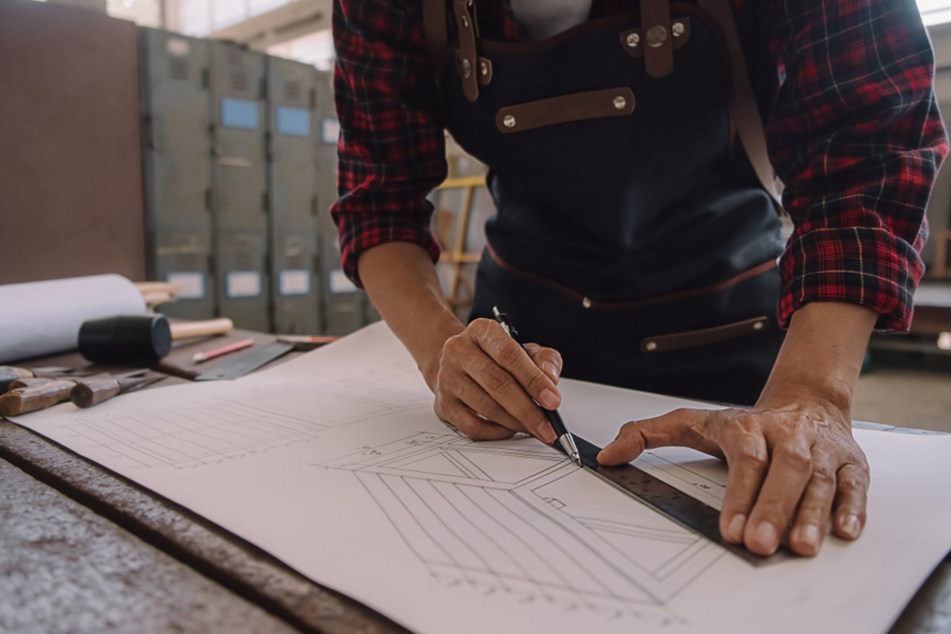A Man is Using a Ruler to Measure — Connolly Bros Kitchens In Bangalow, NSW