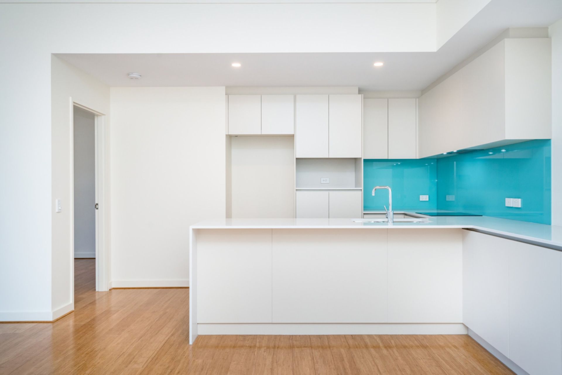 An Empty Kitchen With White Cabinets — Connolly Bros Kitchens In Lismore, NSW