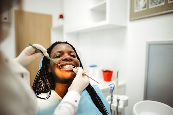 Smiling middle age woman at the dentist for preventative dental care