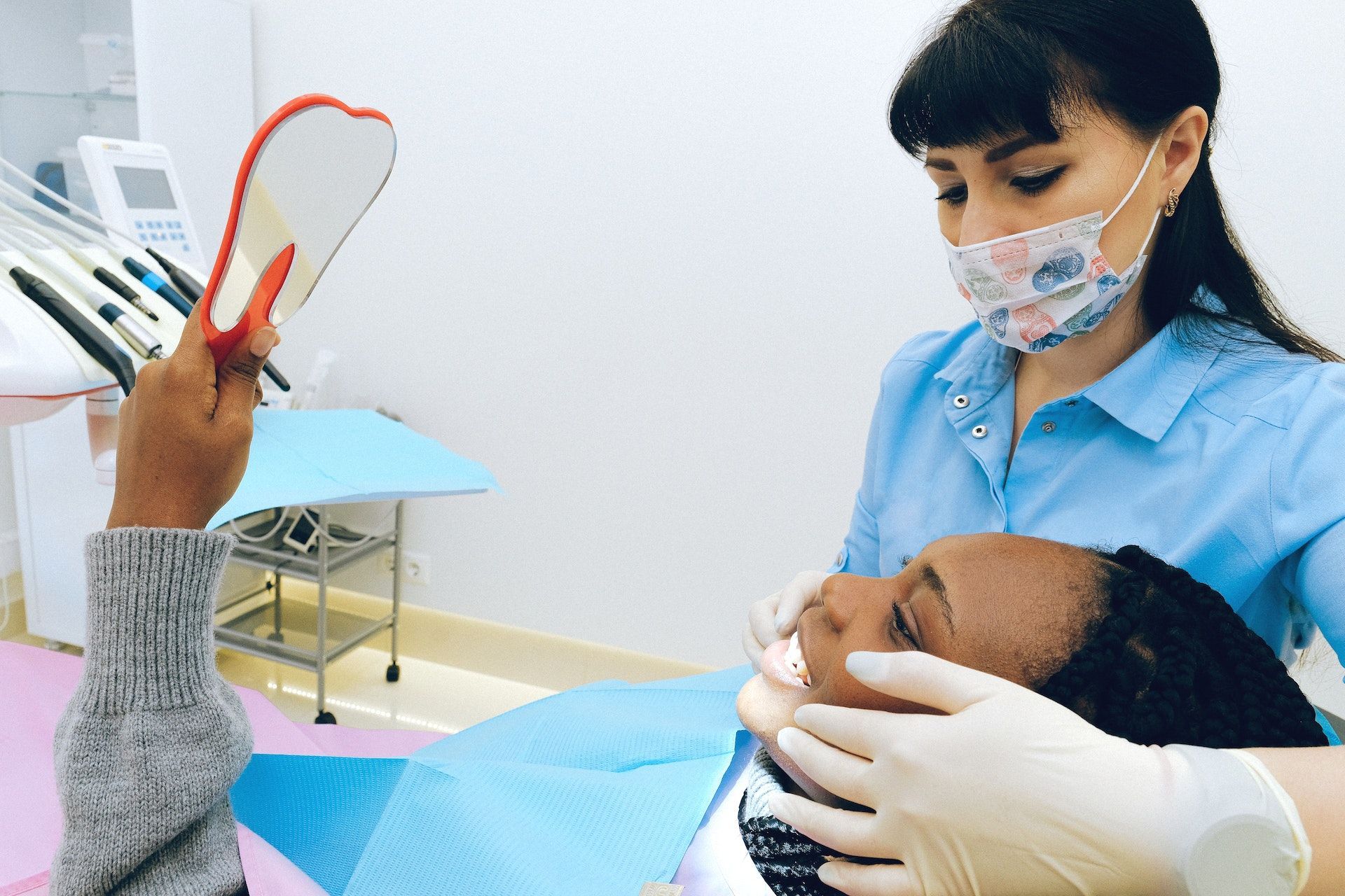 dentist performing dental exam on patient