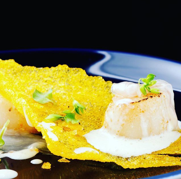 Eine Nahaufnahme eines Tellers mit Essen auf einem Tisch