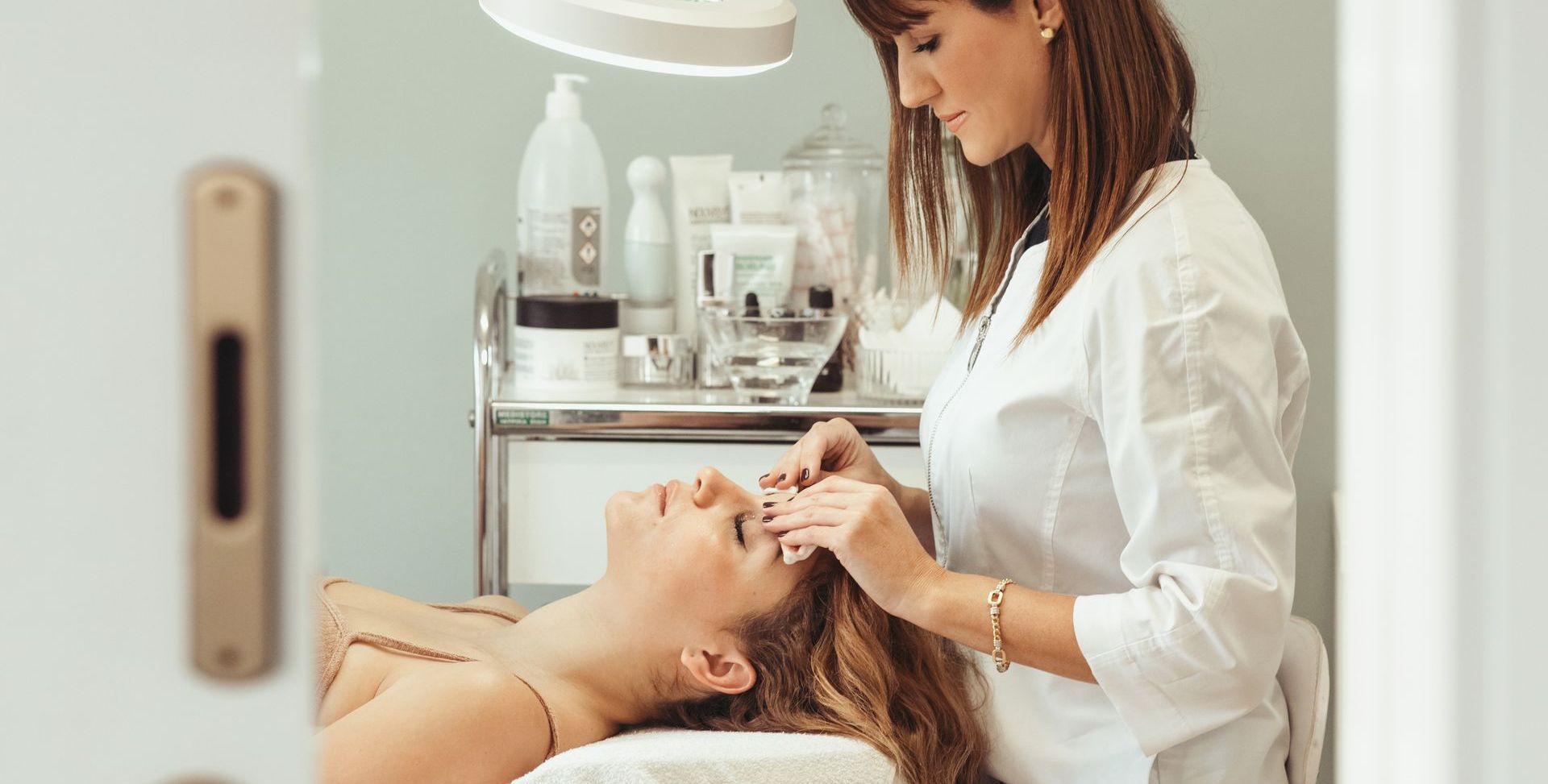 A woman is getting a facial treatment at a beauty salon.