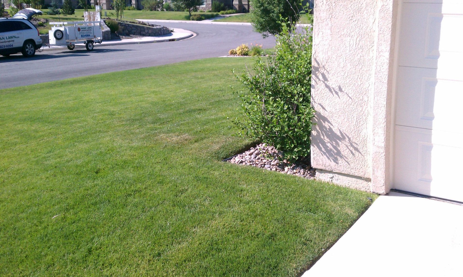 A white truck is parked in front of a house