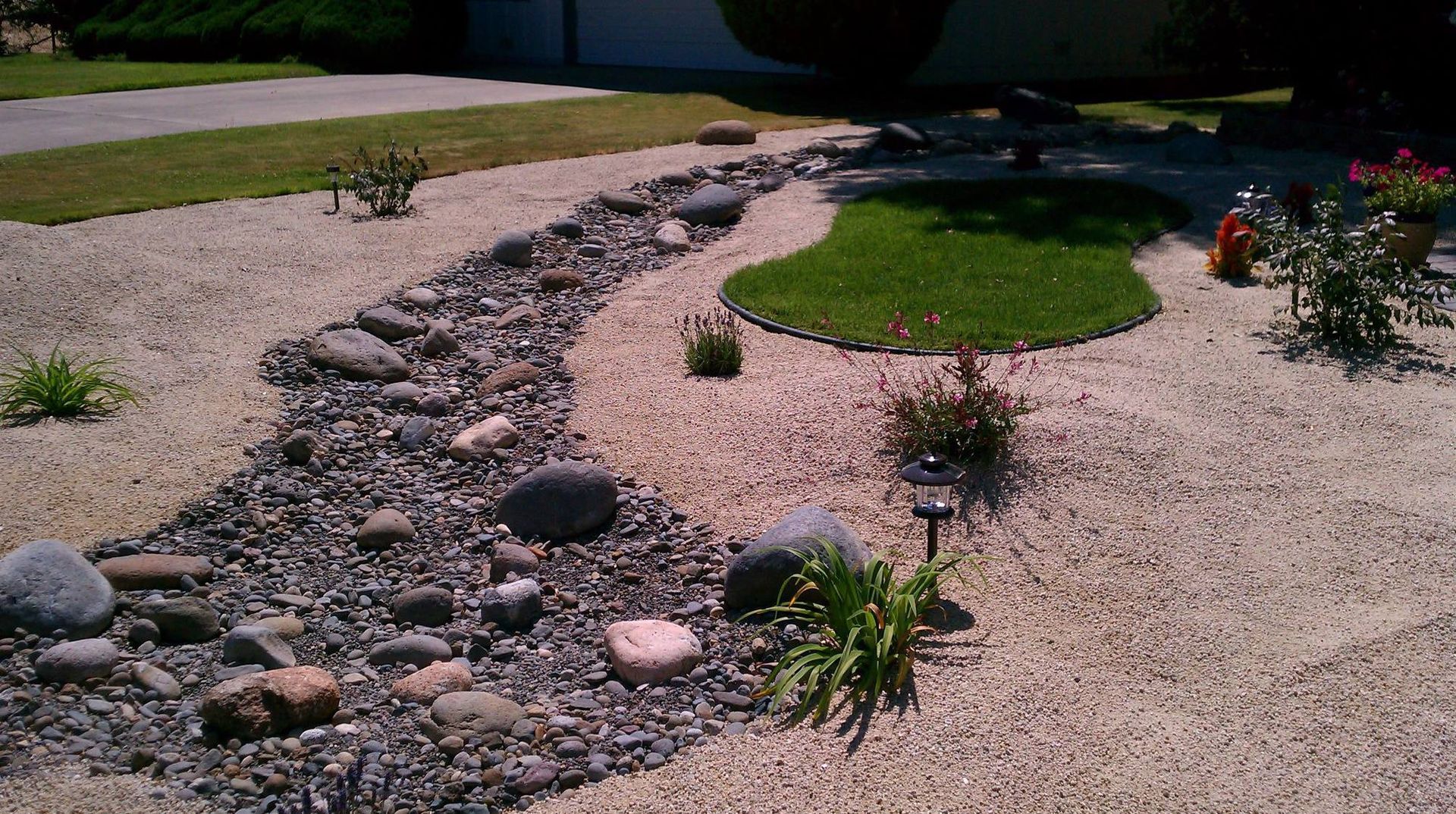 A gravel path runs through a lush green yard