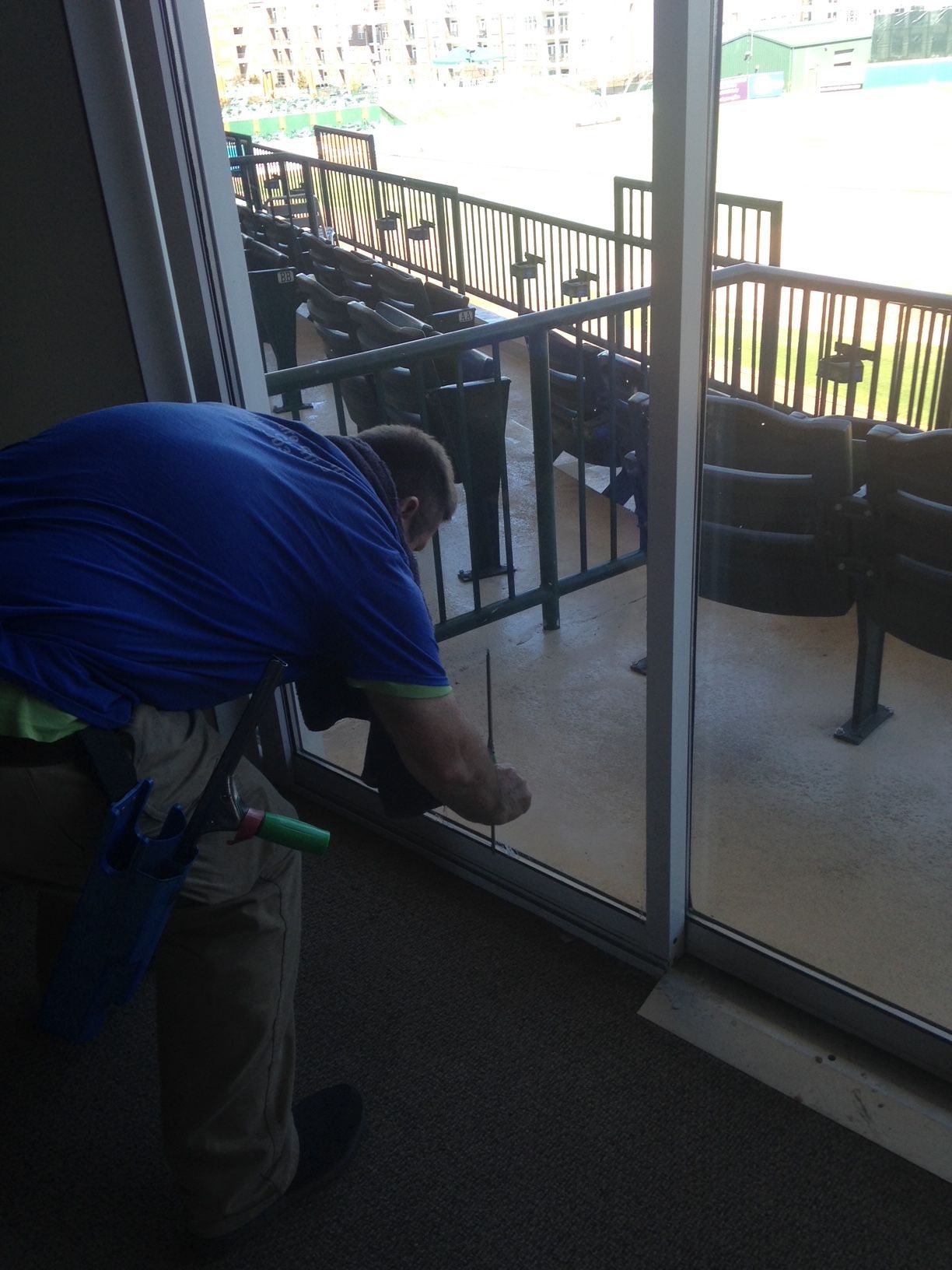 Pressure washer spraying siding on a house, water streaming.