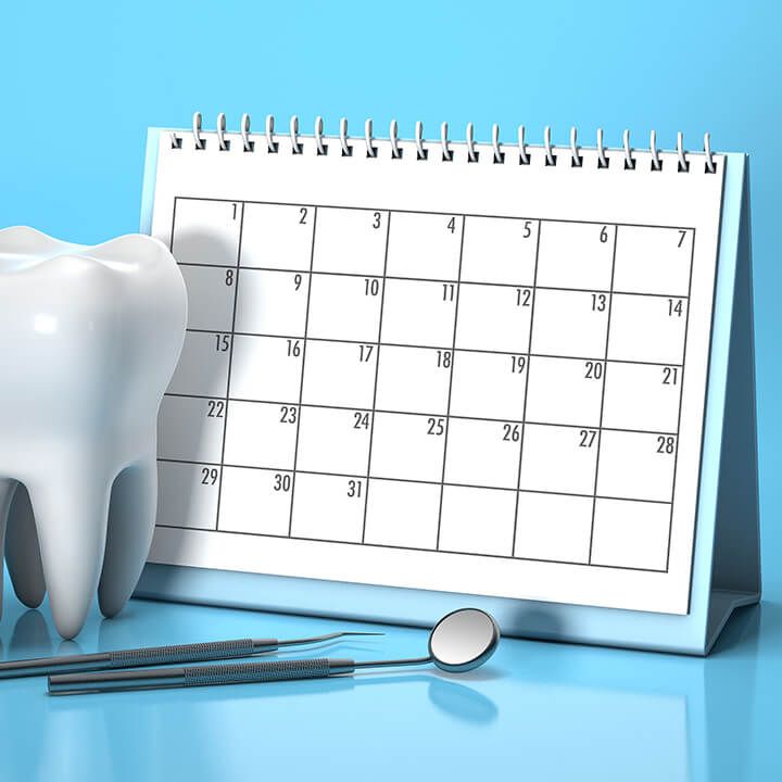 Tooth in front of a calendar