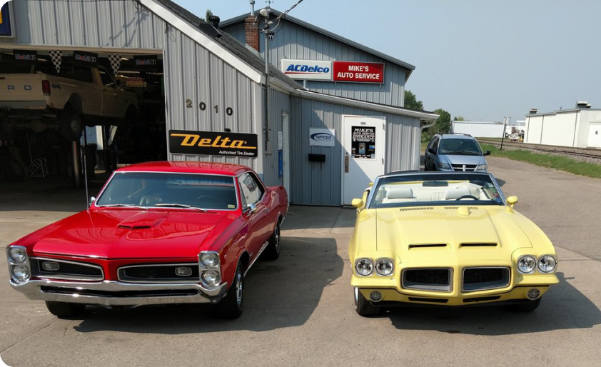 Two Classic Cars Parked Next to Our Service in Moorhead, MI | Mike's Auto Service
