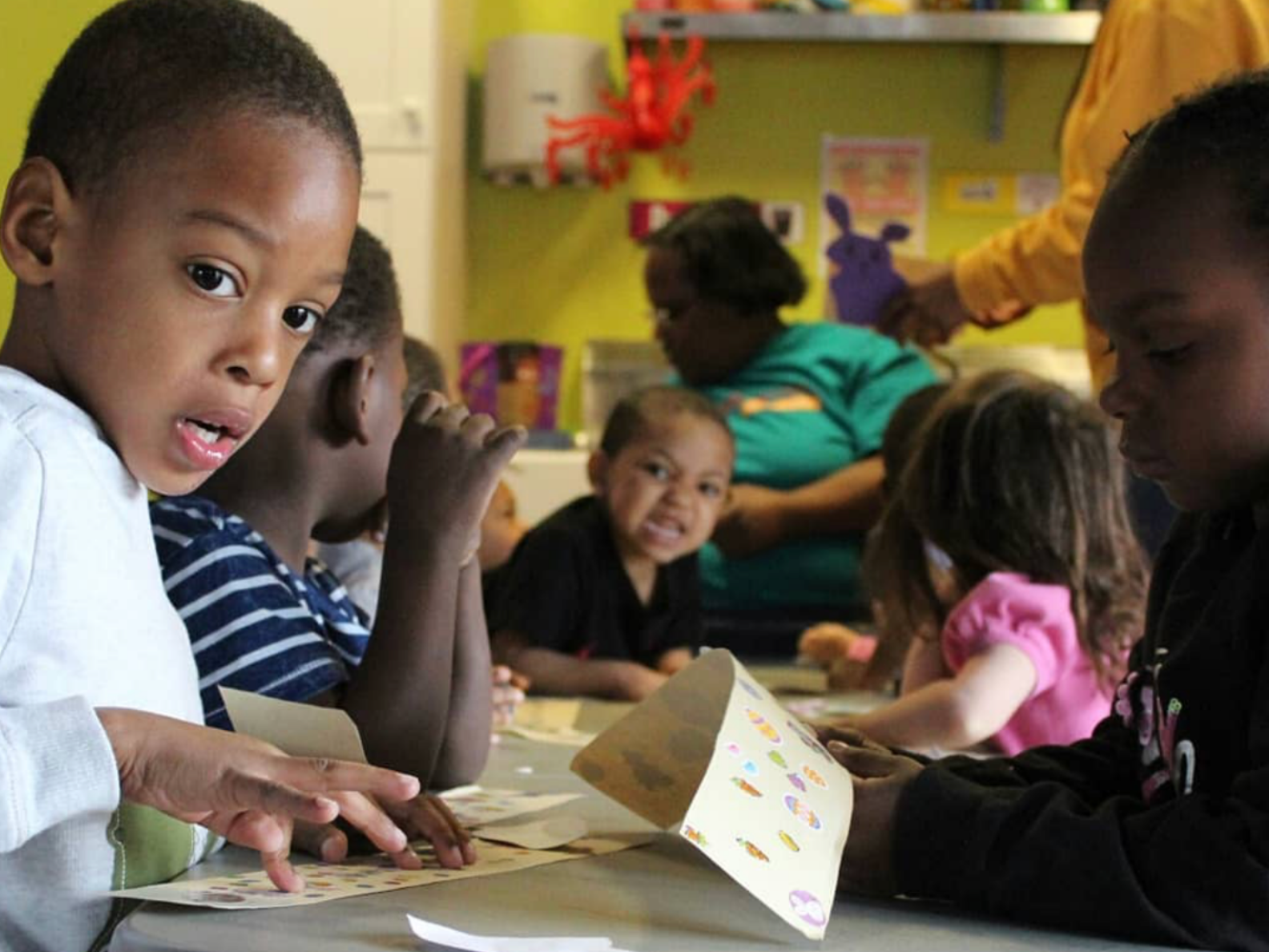Children gathered outside a storefront with a 