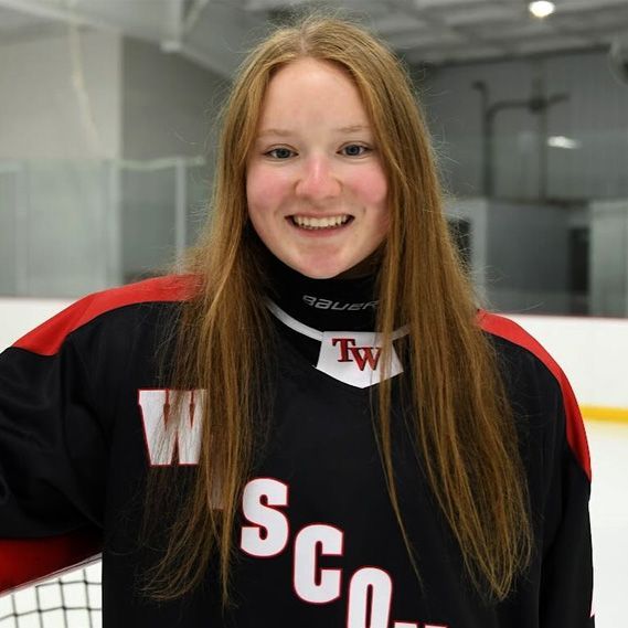 A woman wearing a jersey that says wisconsin on it