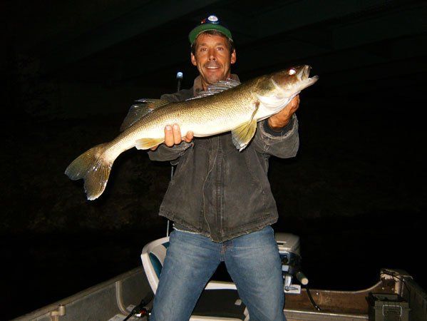 Man Holding a Large Fish — Mound, MN — Schmidt Electric, Inc.