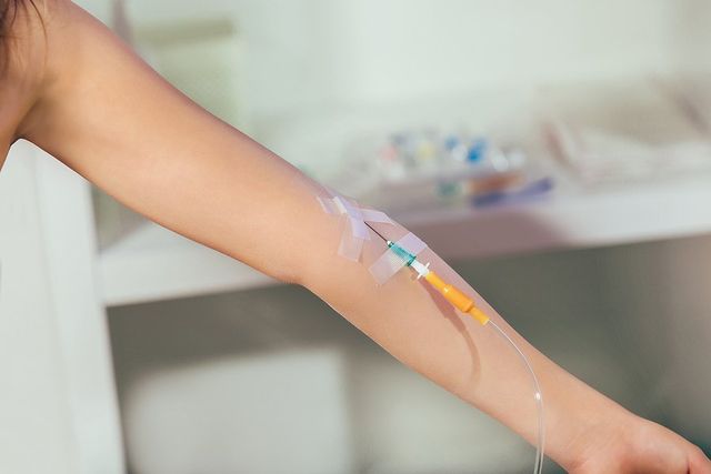 a woman with IV on her arm