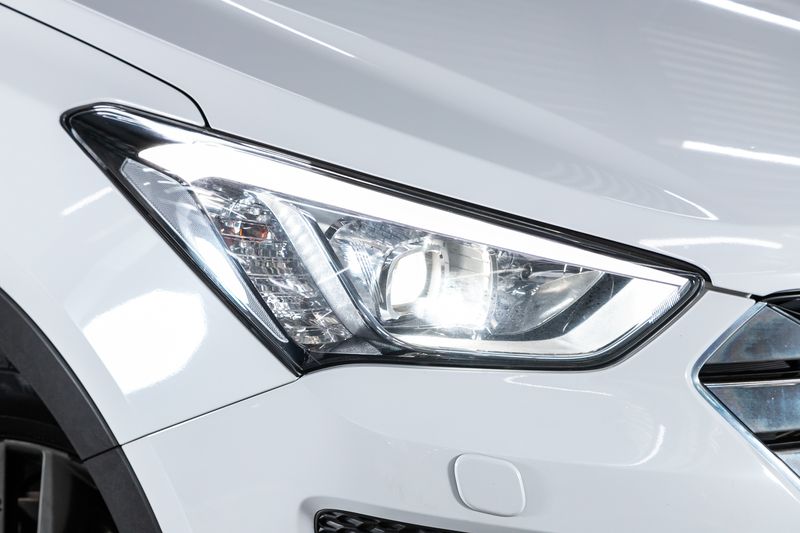 A close up of a white car 's headlight