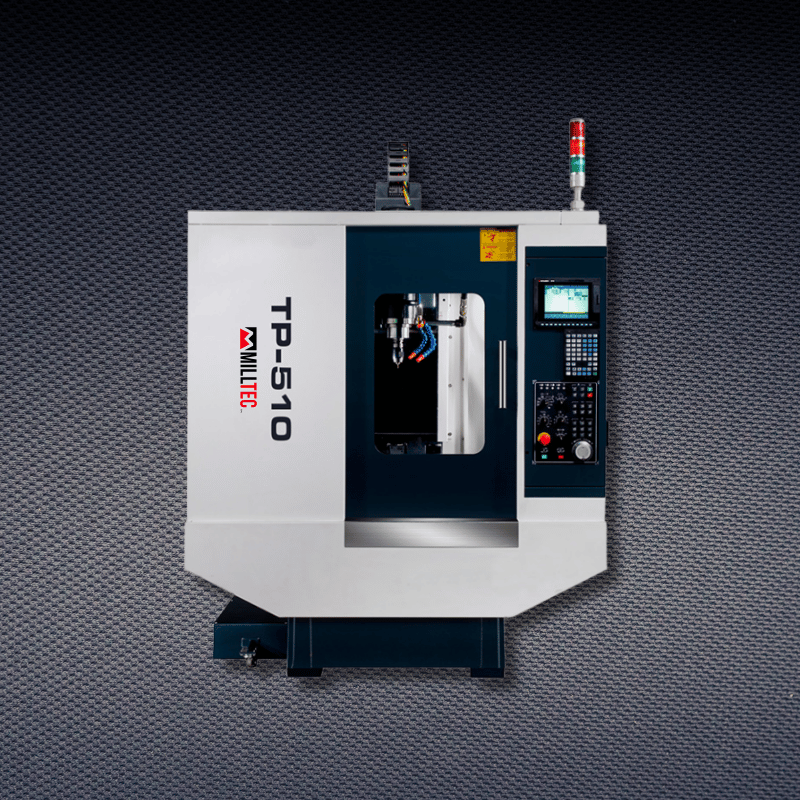 A white and dark blue CNC milling machine labeled TP-510 on a patterned gray background.