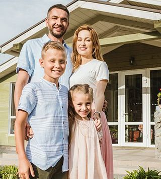 Happy Family Outside House — Greenwood, SC — Mabry Sanders Insurance Agency