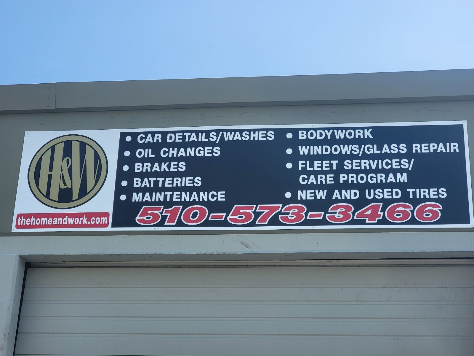 A sign on the side of a building that says ' car details / washes ' on it