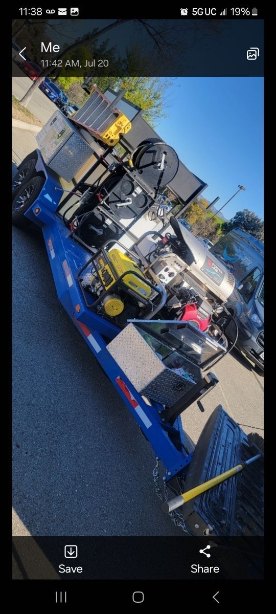 A blue race car is parked on the side of the road.