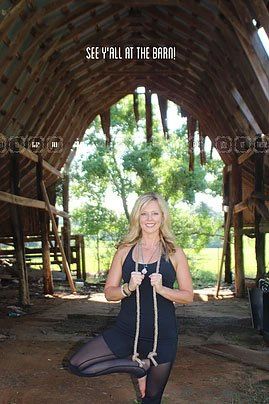 a woman is doing yoga in an old barn .