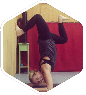 a woman is doing a handstand against a wall .