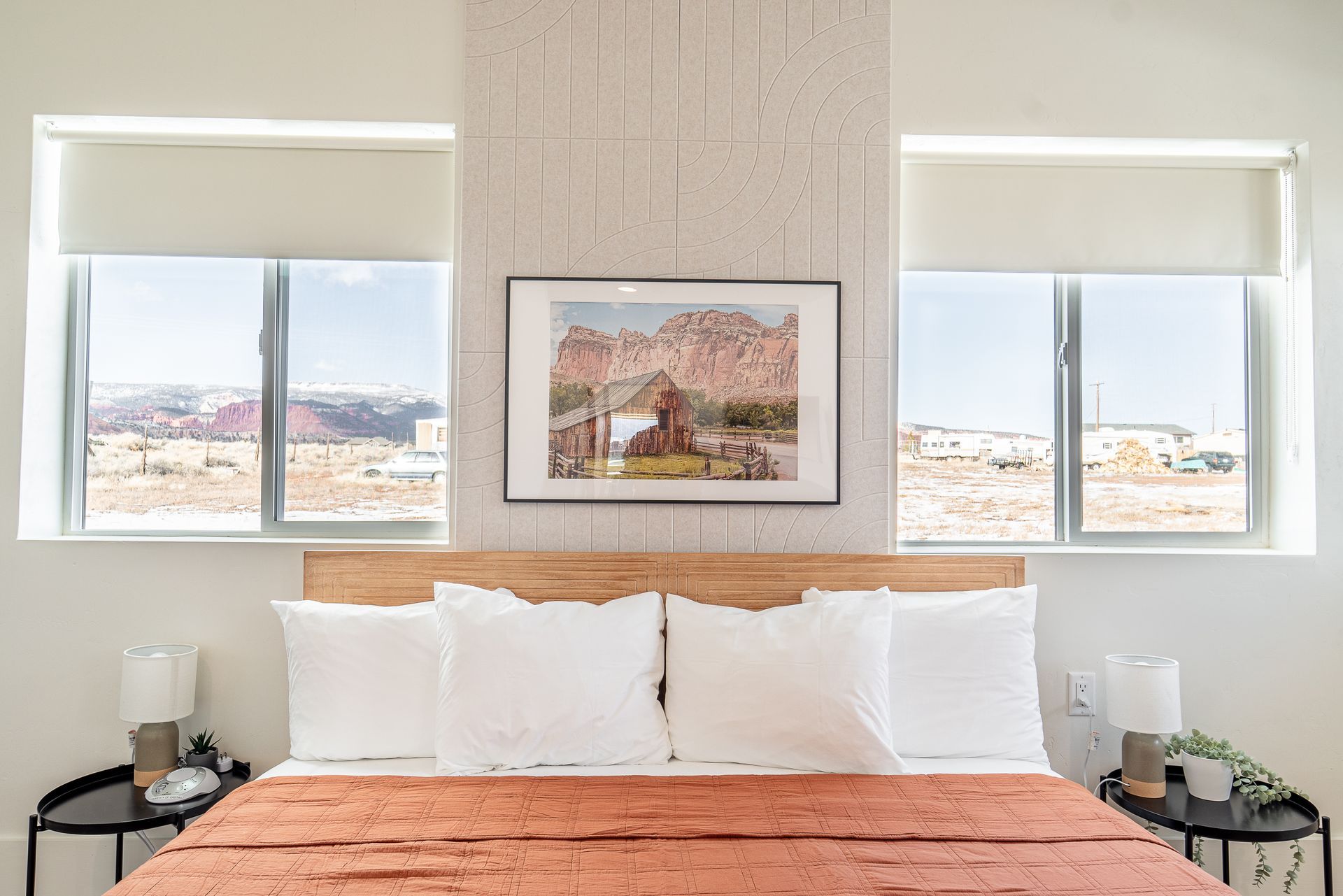 there is a picture on the wall above the bed in the bedroom .