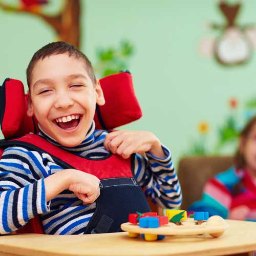 Laughing boy with physical and mental difficulties