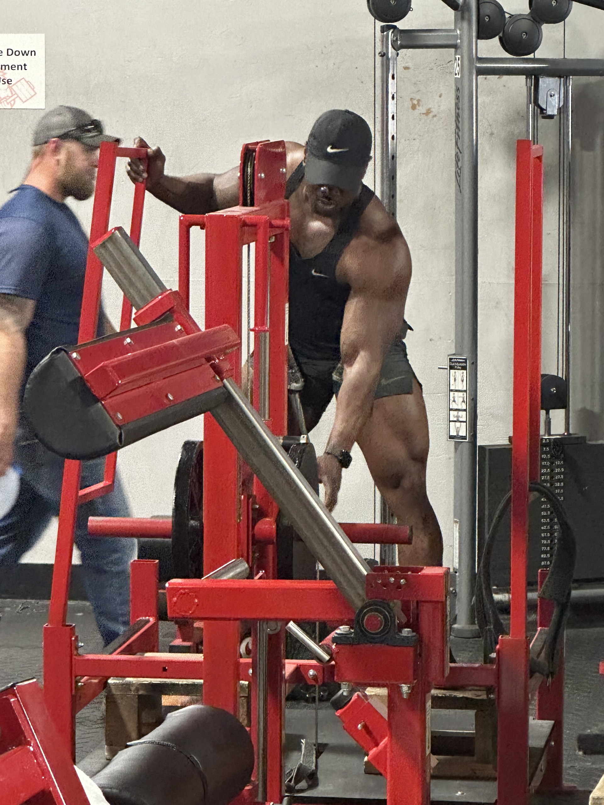 A group of people are posing for a picture in a gym.
