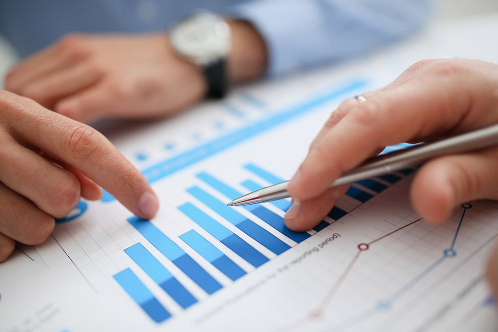 Group of people deliberate on problem with infographics closeup — Town Planning Sunshine Coast, QLD