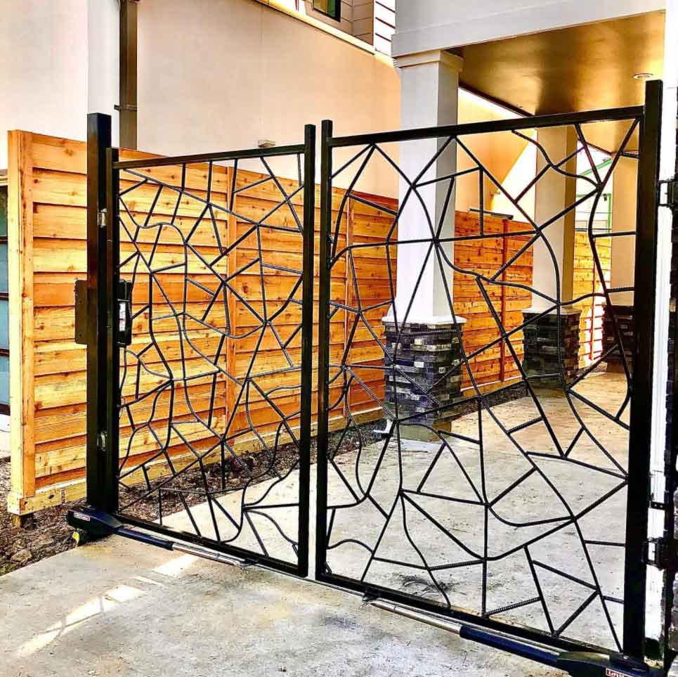 Black Metal Driveway Entrance Gates Set in Brick Fence — Pearland, TX — Fence Keeper