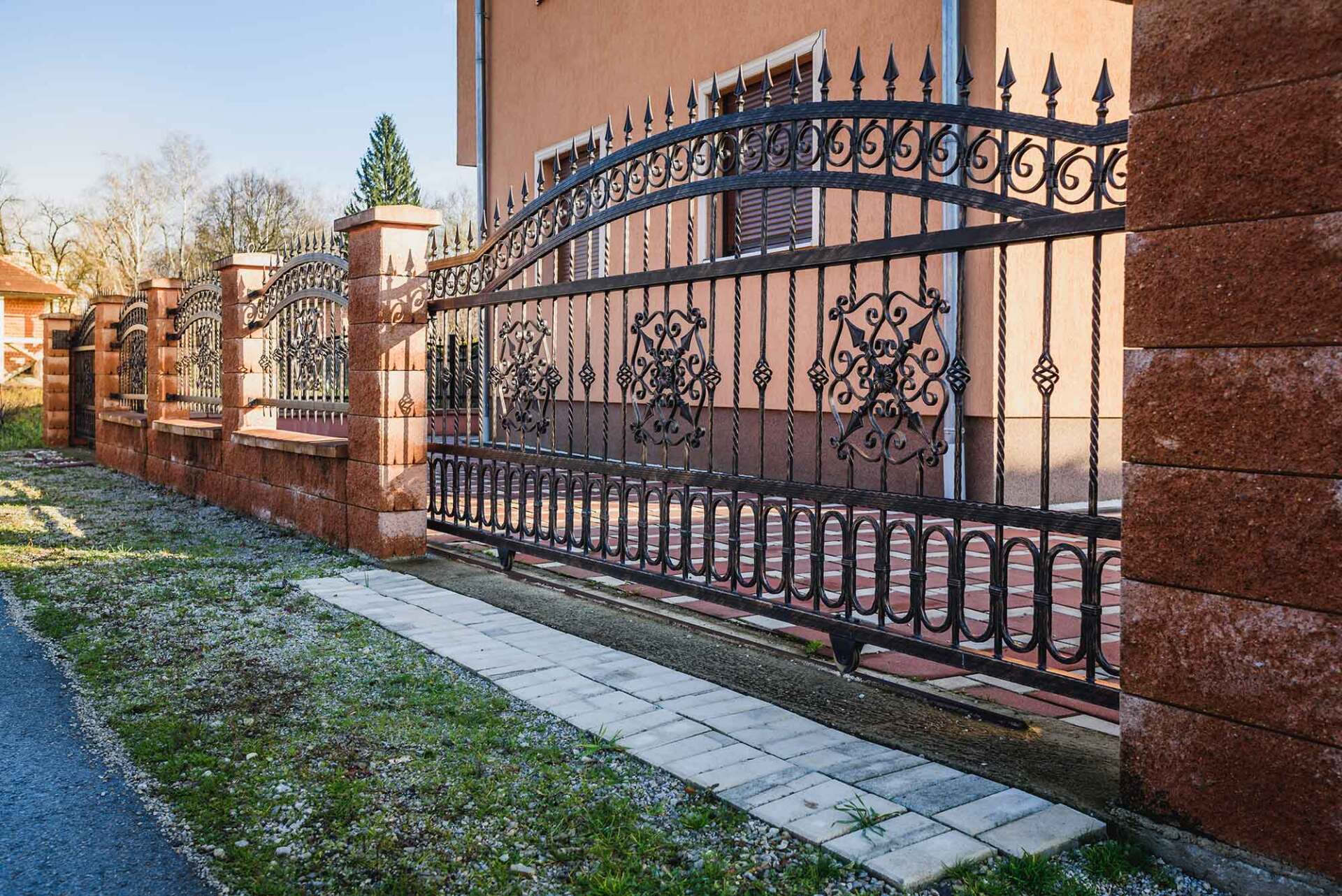Black Wrought Iron Fence with Gate and Brick Wall — Pearland, TX — Fence Keeper