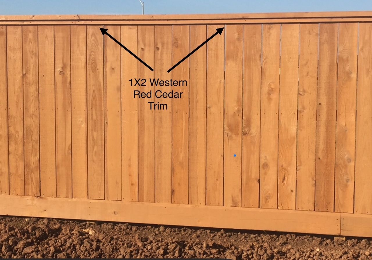 A picture of a wooden fence with the words 1x2 western red cedar trim on it
