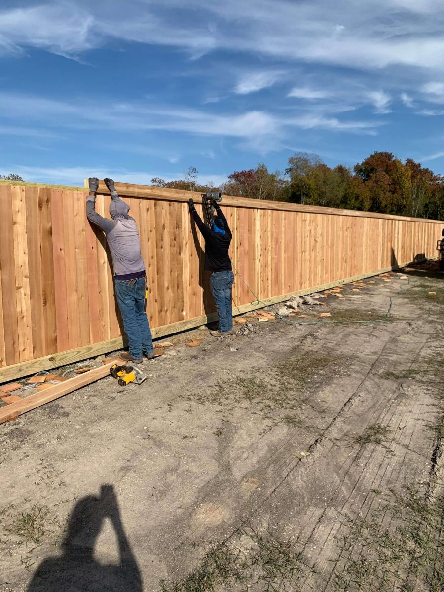 Workers Working on the Wooden Perimeter Fence — Pearland, TX — Fence Keeper
