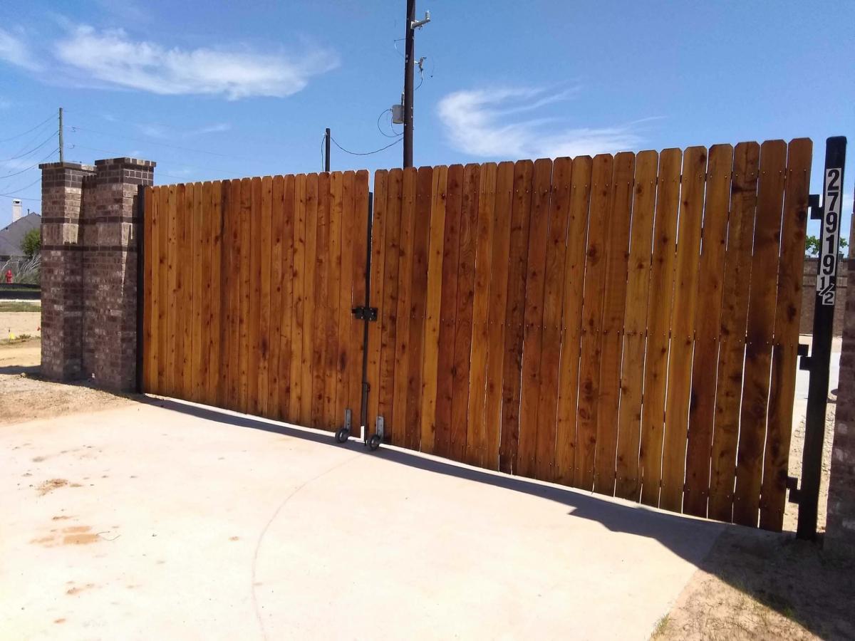 Wooden Gate Set in Brick Fence — Pearland, TX — Fence Keeper