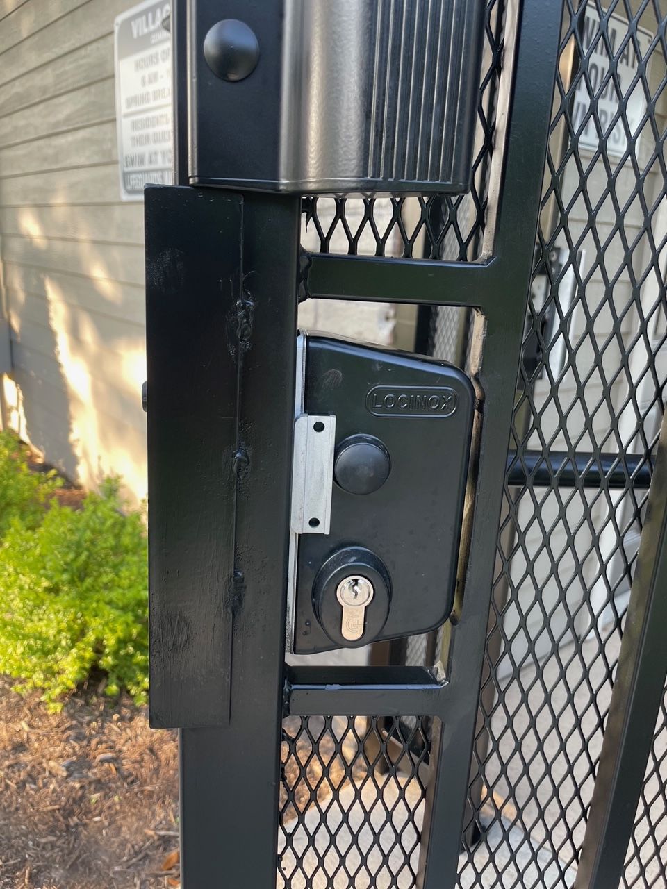 A close up of a gate with a lock on it.