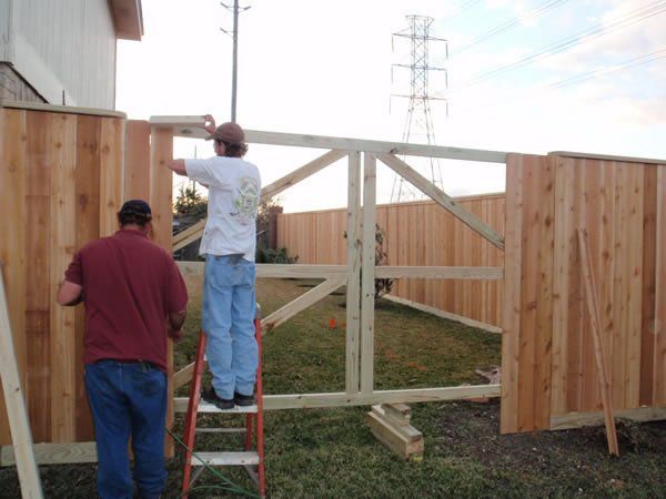Two Workers Working on Wood Fence — Pearland, TX — Fence Keeper