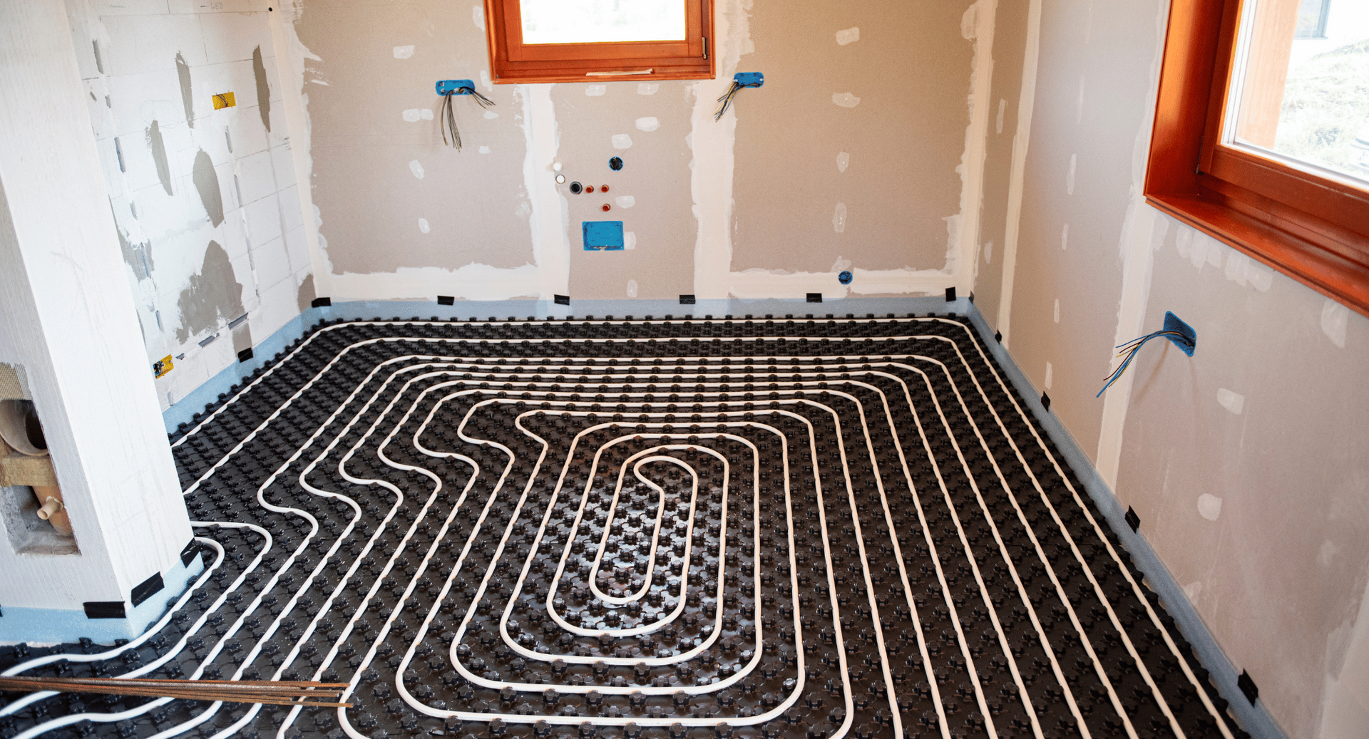 A room with a heating system on the floor.