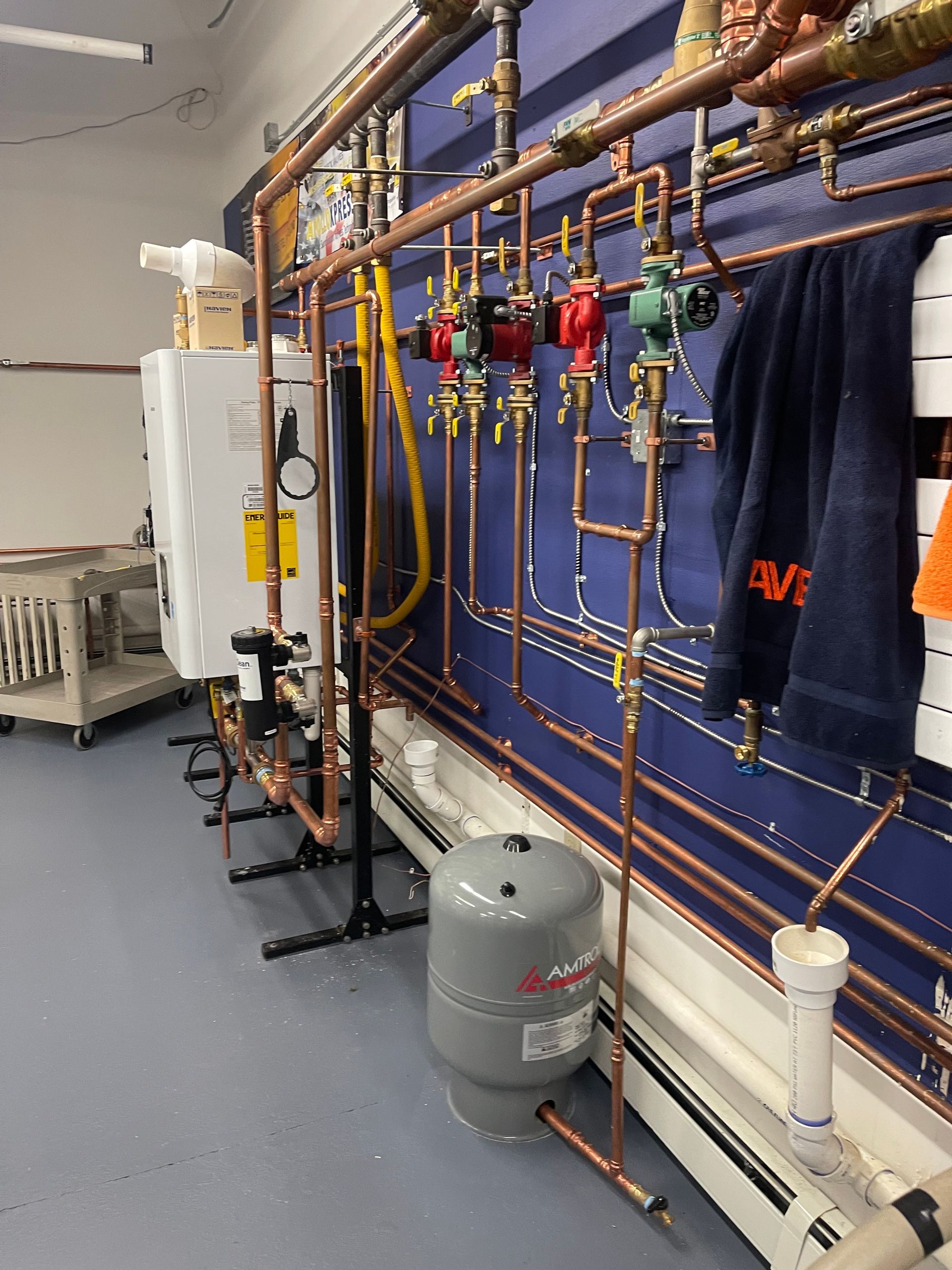 A room with a lot of pipes hanging on the wall