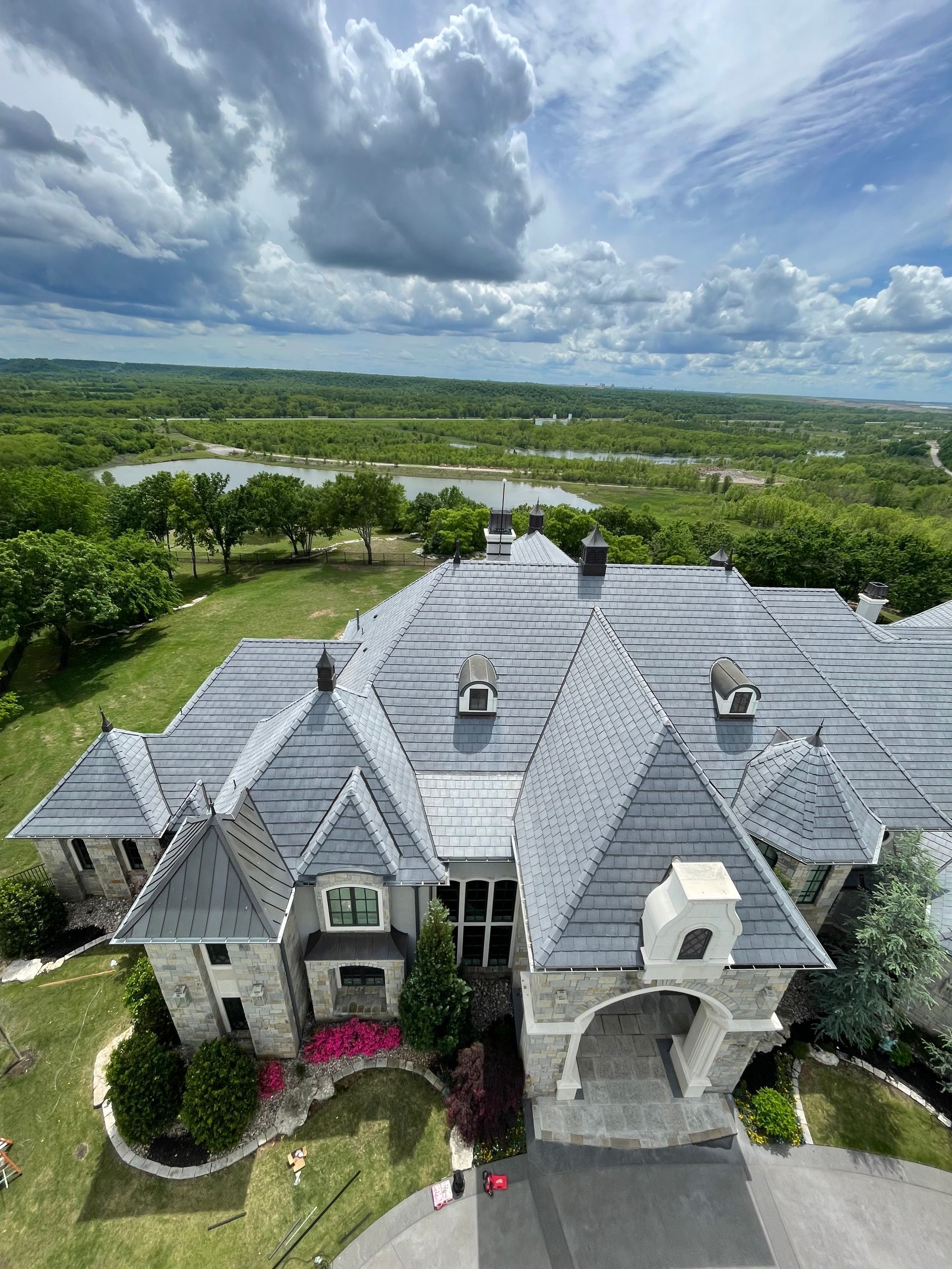 Aerial view of a luxury home in Oklahoma with CMCE system installed on top