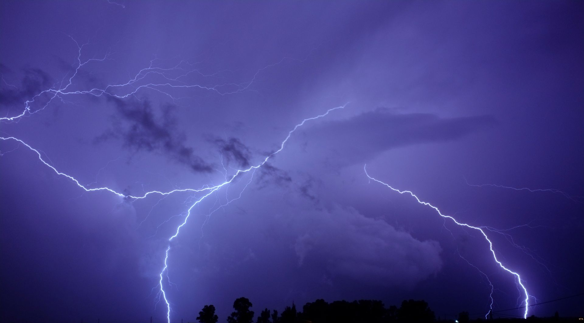 Lightning strikes in a dark, cloudy sky
