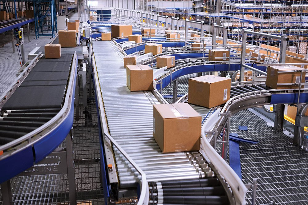 A conveyor belt filled with boxes in a warehouse