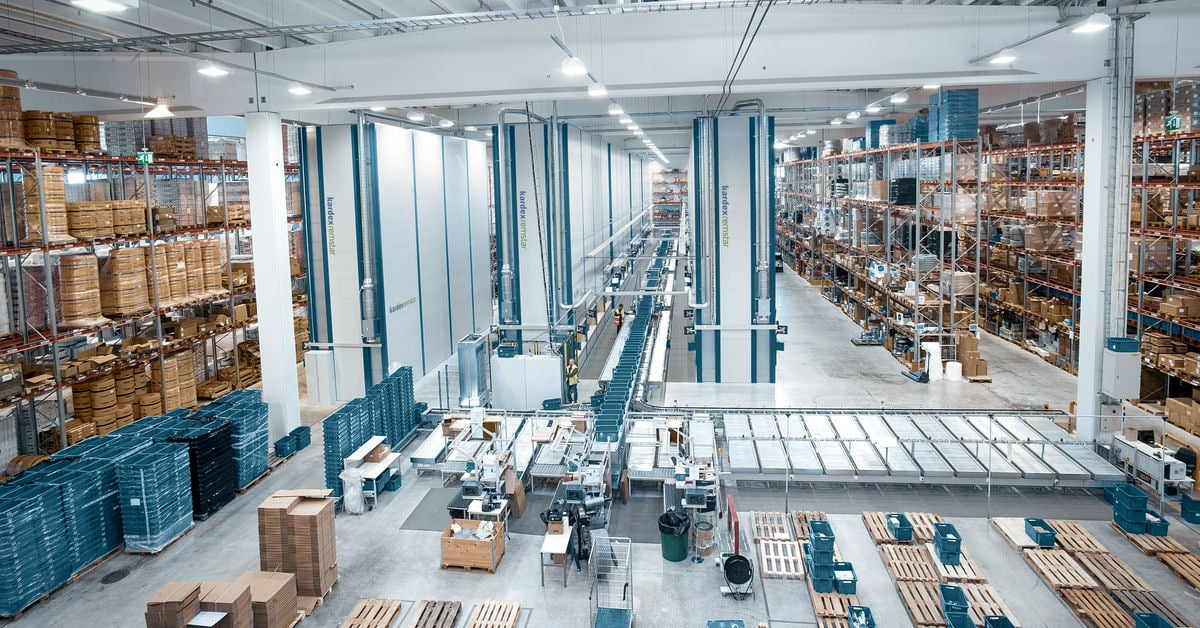 A large warehouse filled with lots of boxes and shelves.
