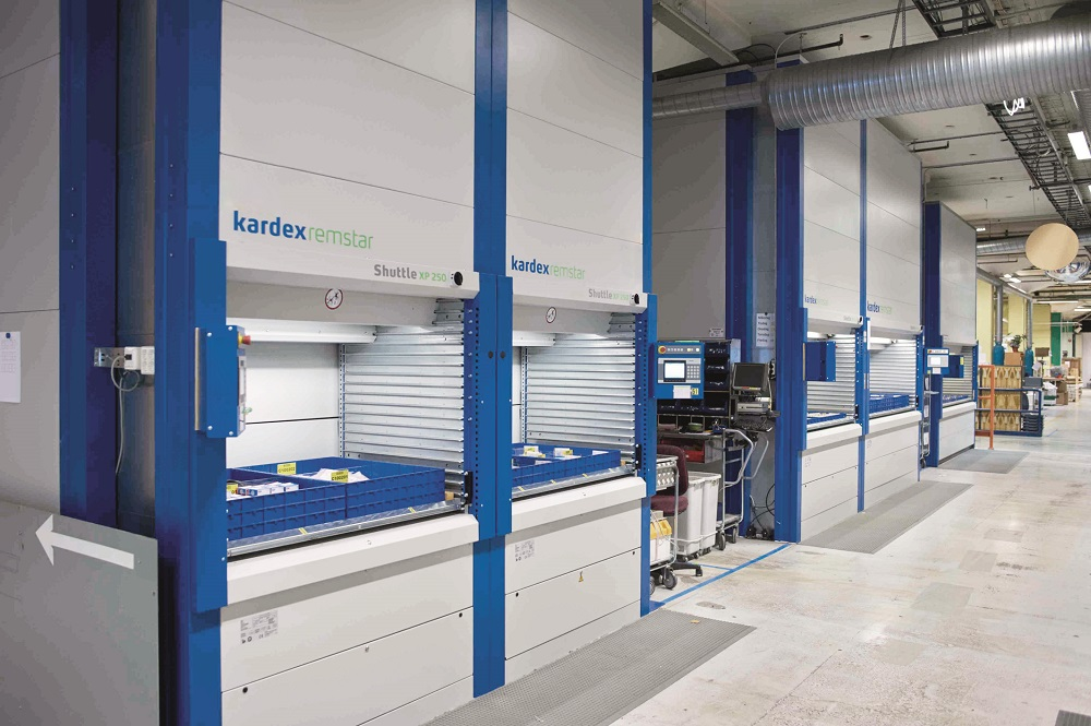 A warehouse with a lot of shelves and a machine that says kandex on it