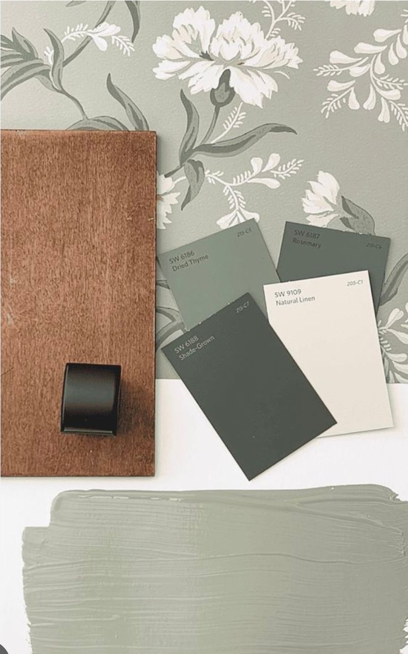 Color swatches, brown wood, and a black handle, with floral wallpaper.