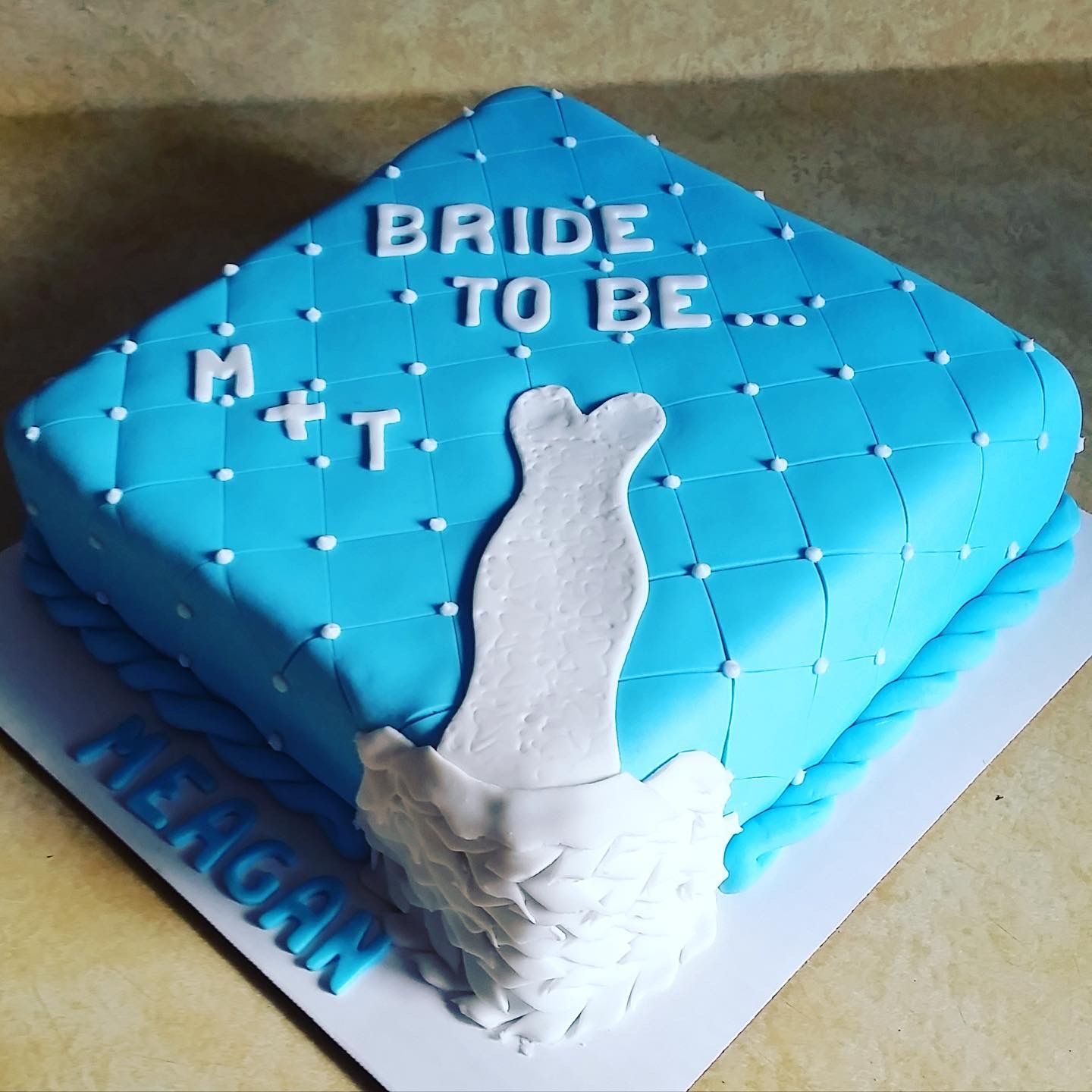 A blue cake that says bride to be on it