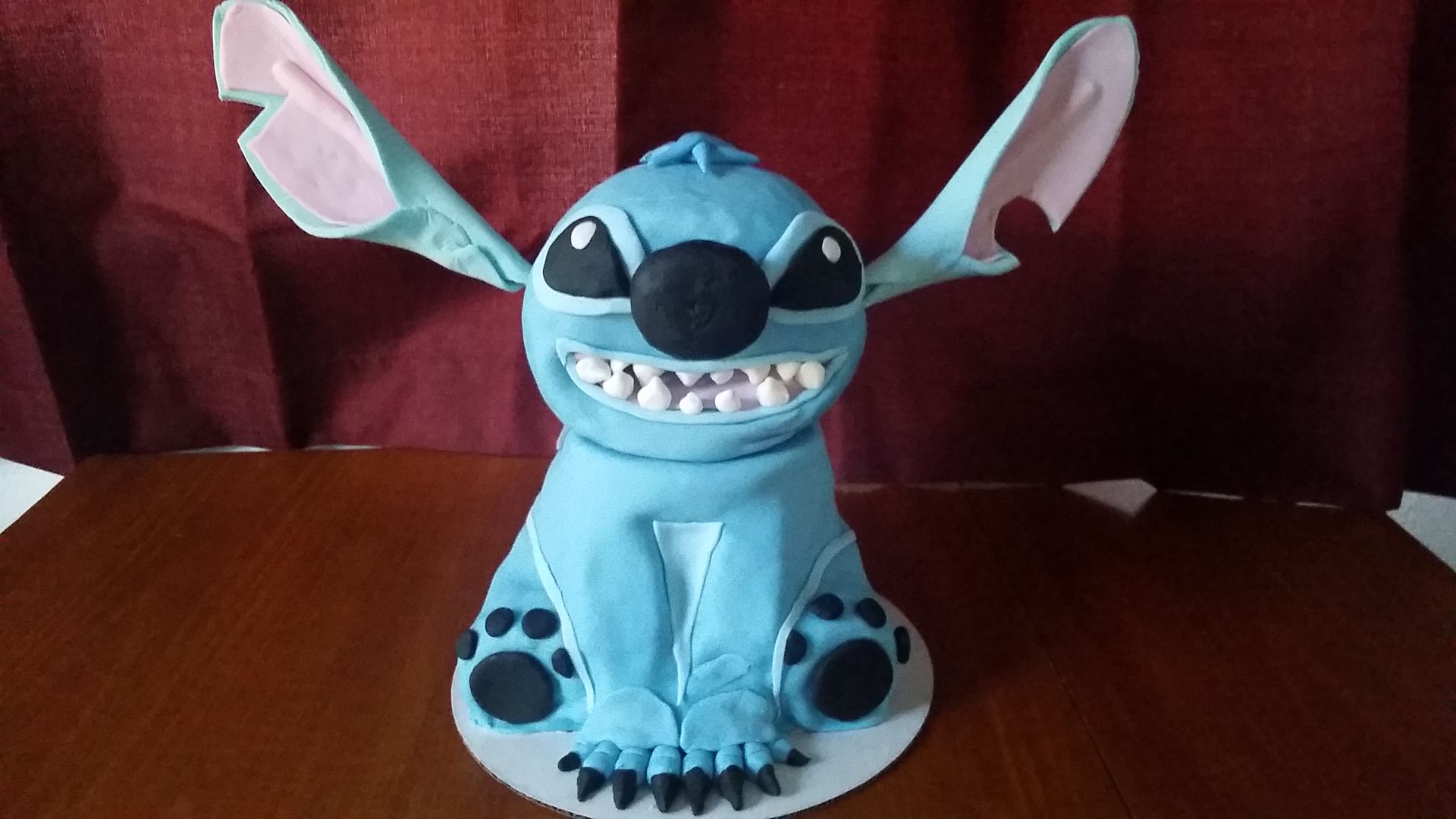 A stitch cake is sitting on a wooden table