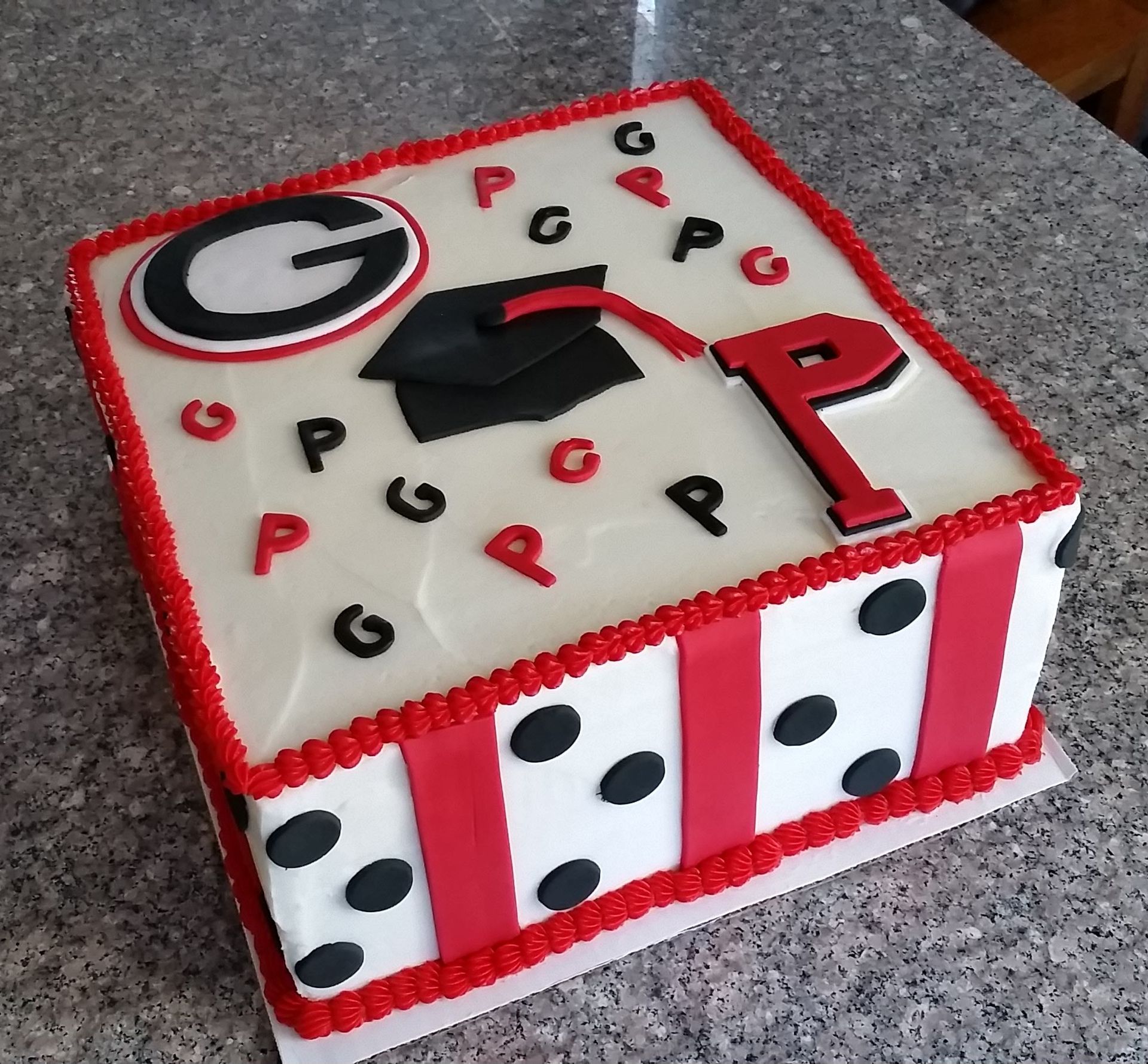 A cake with a graduation cap and the letter p on it