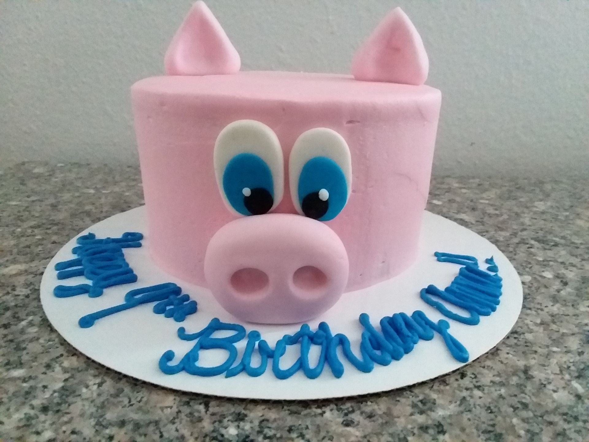A birthday cake with a pig on it